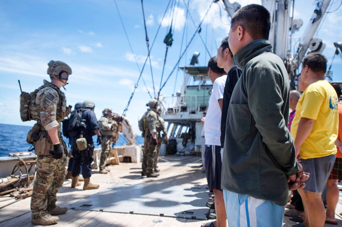 Coast Guardsmen muster the crew of a foreign-flagged fishing vessel during an Oceania Maritime Security Initiative boarding mission in the Pacific Ocean, Feb. 17, 2017. Navy photo by Petty Officer 3rd Class Danny Kelley