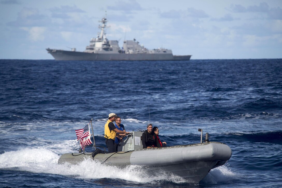Sailors maneuver a rigid hull inflatable boat toward a foreign-flagged fishing vessel during an Oceania Maritime Security Initiative boarding mission in the Pacific Ocean, Feb. 17, 2017. Navy photo by Petty Officer 3rd Class Danny Kelley