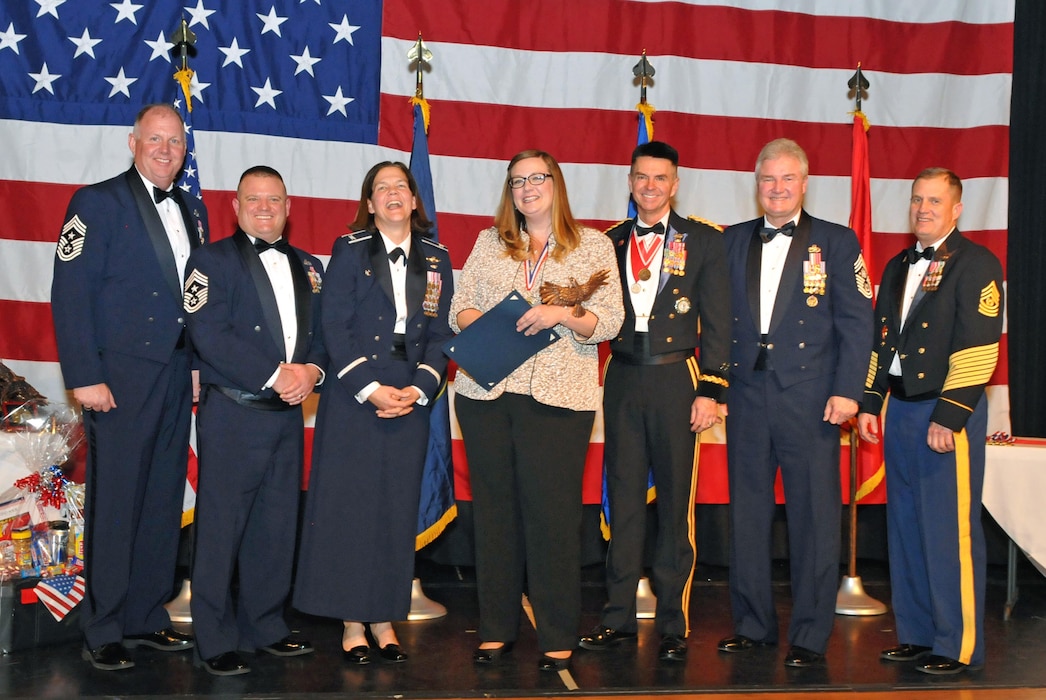 Ms. Jackie Ezell with the 151st Mission Support Group accepts her award for Civilian of the Year during the Utah Air National Guard 2016 Airman of the Year awards banquet held at the Utah Cultural Center in West Valley, Utah on Jan. 21, 2017. (U.S. Air National Guard photo by Tech. Sgt. Annie Edwards)