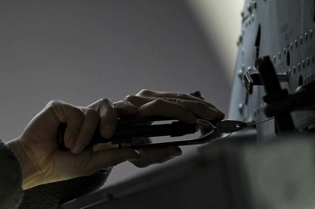 A weapons load crew member assigned to the 25th Maintenance Unit secures a wire while preparing an A-10 Thunderbolt II for a mission during Exercise Beverly Herd 17-1, Feb. 27, 2017, at Osan Air Base, Republic of Korea. Airmen assigned to the 51st Maintenance Group were responsible for quickly spinning up aircraft and preparing them for missions with limited-to-no notice. (U.S. Air Force photo by Staff Sgt. Victor J. Caputo)