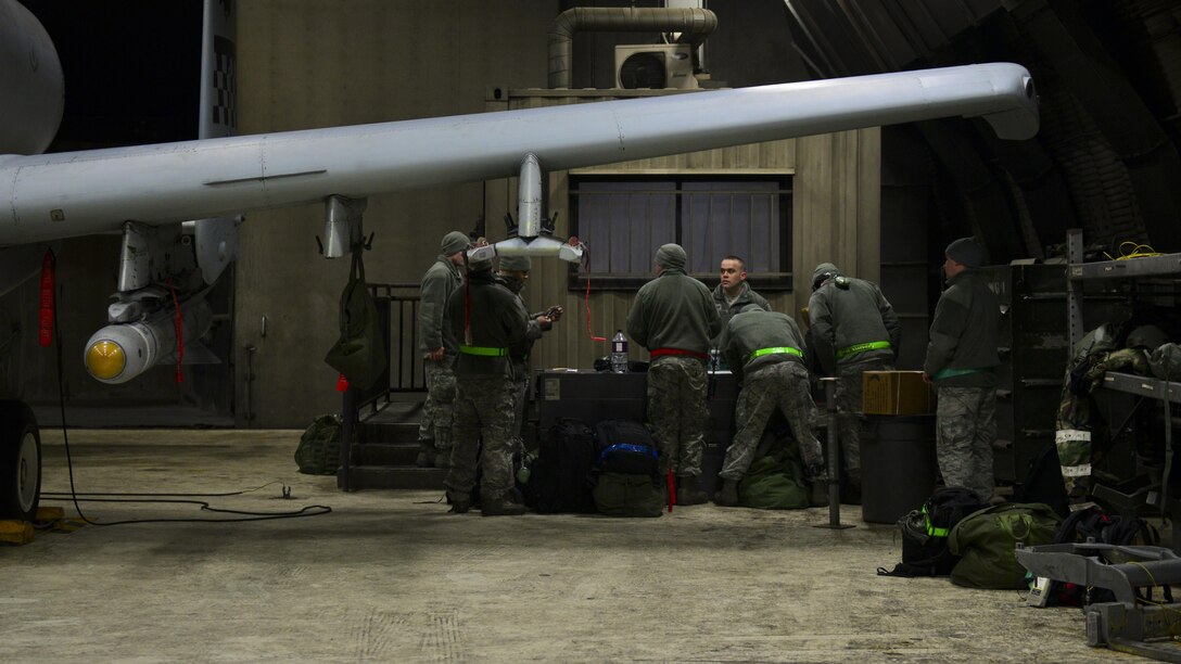 Airmen assigned to the 51st Maintenance Group discuss working orders Feb. 27, 2017, during Exercise Beverly Herd 17-1 at Osan Air Base, Republic of Korea. Exercise BH 17-1 tested the 51st Maintenance Group’s capability to quickly generate airpower for missions. (U.S. Air Force photo by Staff Sgt. Victor J. Caputo)