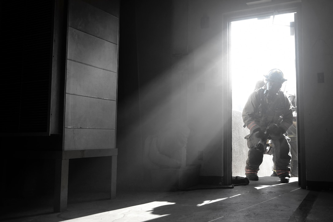 A firefighter from the 51st Civil Engineering Squadron responds to a simulated warehouse fire during Exercise Beverly Herd 17-1, Feb. 27, 2017, at Osan Air Base, Republic of Korea. The exercise focused on the ability for 51st Fighter Wing personnel to train on their wartime missions. (U.S. Air Force photo by Airman 1st Class Gwendalyn Smith)
