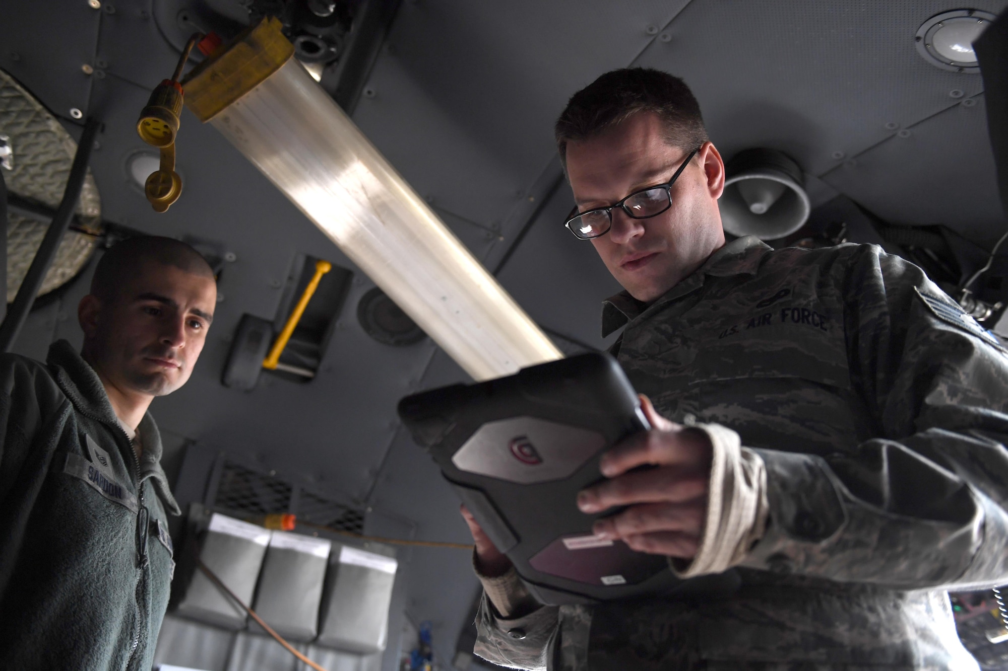 Tech. Sgt. Benjamin Sardon and Staff Sgt. Jacob Liebel, communication and navigation systems technicians with the 911th Aircraft Maintenance Squadron, perform a functional check on the Real Time In Cockpit modification at the Pittsburgh International Airport Air Reserve Station, Feb. 8, 2017. RTIC was installed in five of the eight C-130 Hercules aircraft assigned to the 911th Airlift Wing to improve situational awareness of pilots. (U.S. Air Force photo by Staff Sgt. Marjorie A. Bowlden)