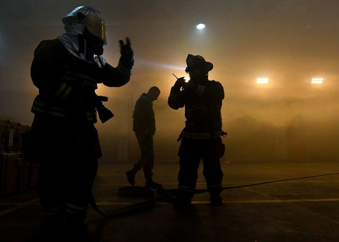 Firefighters from the 51st Civil Engineering Squadron respond to a simulated warehouse fire during Exercise Beverly Herd 17-1, Feb. 27, 2017, at Osan Air Base, Republic of Korea. The simulation was executed to better equip members of Team Osan with the knowledge and experience to carry out and sustain the mission and operations with our Republic of Korea allies.  (U.S. Air Force photo by Airman 1st Class Gwendalyn Smith)