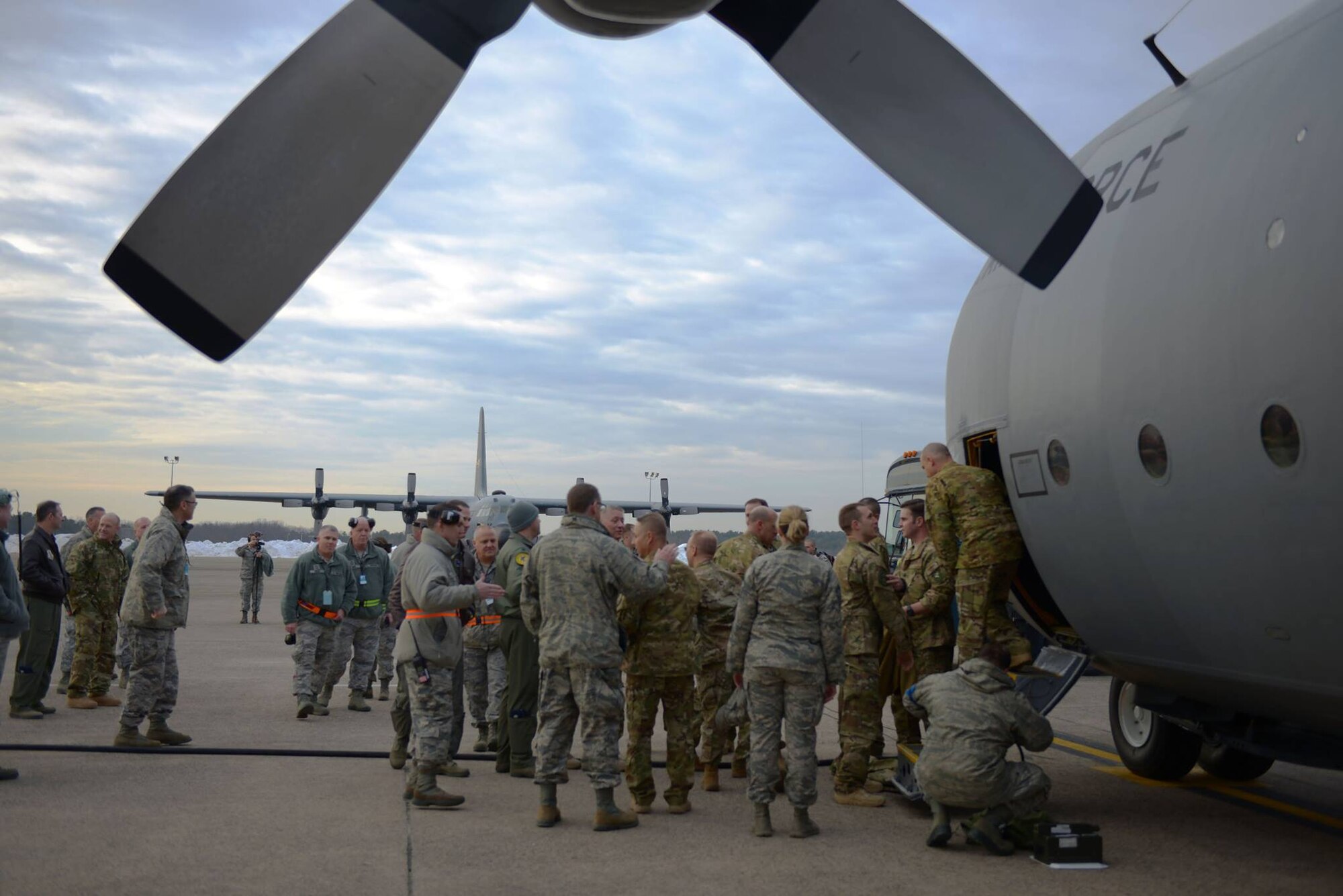 Final farewells are made as deploying 103rd Airmen board the C-130 Hercules that will fly them to their deployment locations from Bradley Air National Guard Base, East Granby, Conn., Feb. 22, 2017. (U.S. Air National Guard photo by 2nd Lt. Jen Pierce)