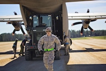 Senior Airman Diego O'Neal, air transportation, 71st Aerial Port Squadron, moves away from the loading crew during training at the Joint Readiness Training Center, Fort Polk, Louisiana, Feb. 15, 2017.  O'Neal joined other Airmen from the 512th Airlift Wing located at Dover Air Force Base, Del., to conduct training and provide support to Army units who were training also at JRTC. (U.S. Air Force photo/Capt. Bernie Kale)