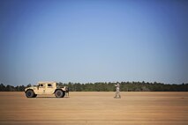 Tech. Sgt. Stephen Thomas, air transportation, 71st Aerial Port Squadron, ground guides a Humvee during flight line operations at the Joint Readiness Training Center, Fort Polk, Louisiana, Feb. 15, 2017. Thomas joined other Airmen from the 512th Airlift Wing located at Dover Air Force Base, Del., to conduct training and provide support to Army units who were training also at JRTC. (U.S. Air Force photo/Capt. Bernie Kale)