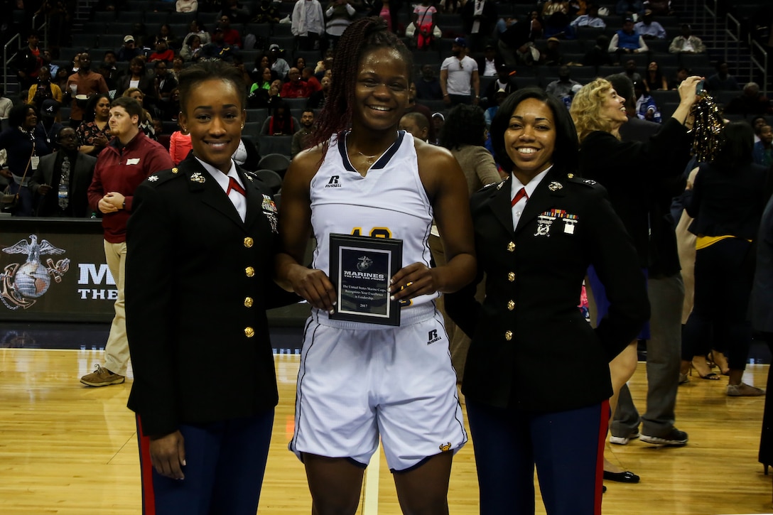 Lieutenant Col. Marshalee E. Clarke, congressional liaison for the Office of The Assistant Secretary, left, and Capt. Joanna Reynolds, the regional advertising officer for 6th Marine Corps District, present the Marine Corps Excellence in Leadership Award to Blaire Thomas of Johnson C. Smith University following the women’s semifinals game of the Central Intercollegiate Athletic Association (CIAA) championships at the Spectrum Center in Charlotte, N.C., Feb. 25, 2017.  Johnson C. Smith University defeated Virginia State University 68 to 59. The Marines are present at the Central Intercollegiate Athletic Association championships to spread awareness to student athletes and fans about career and educational opportunities in the Marine Corps. (U.S. Marine Corps photo by Lance Cpl. Jack A. E. Rigsby/Released)