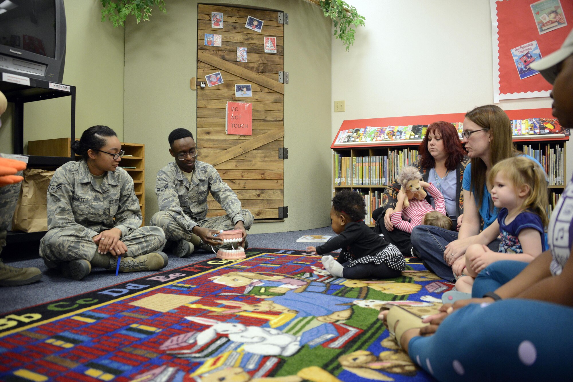 56th Dental Squadron Airmen show children how to properly brush their teeth during their visit to the base library at Luke Air Force Base, Ariz., Feb. 15, 2017.The 56th Dental Squadron is celebrating National Children's Dental Health Month and wants to educate parents on how to care for their children's teeth. (U.S. Air Force photo by Senior Airman Devante Williams)