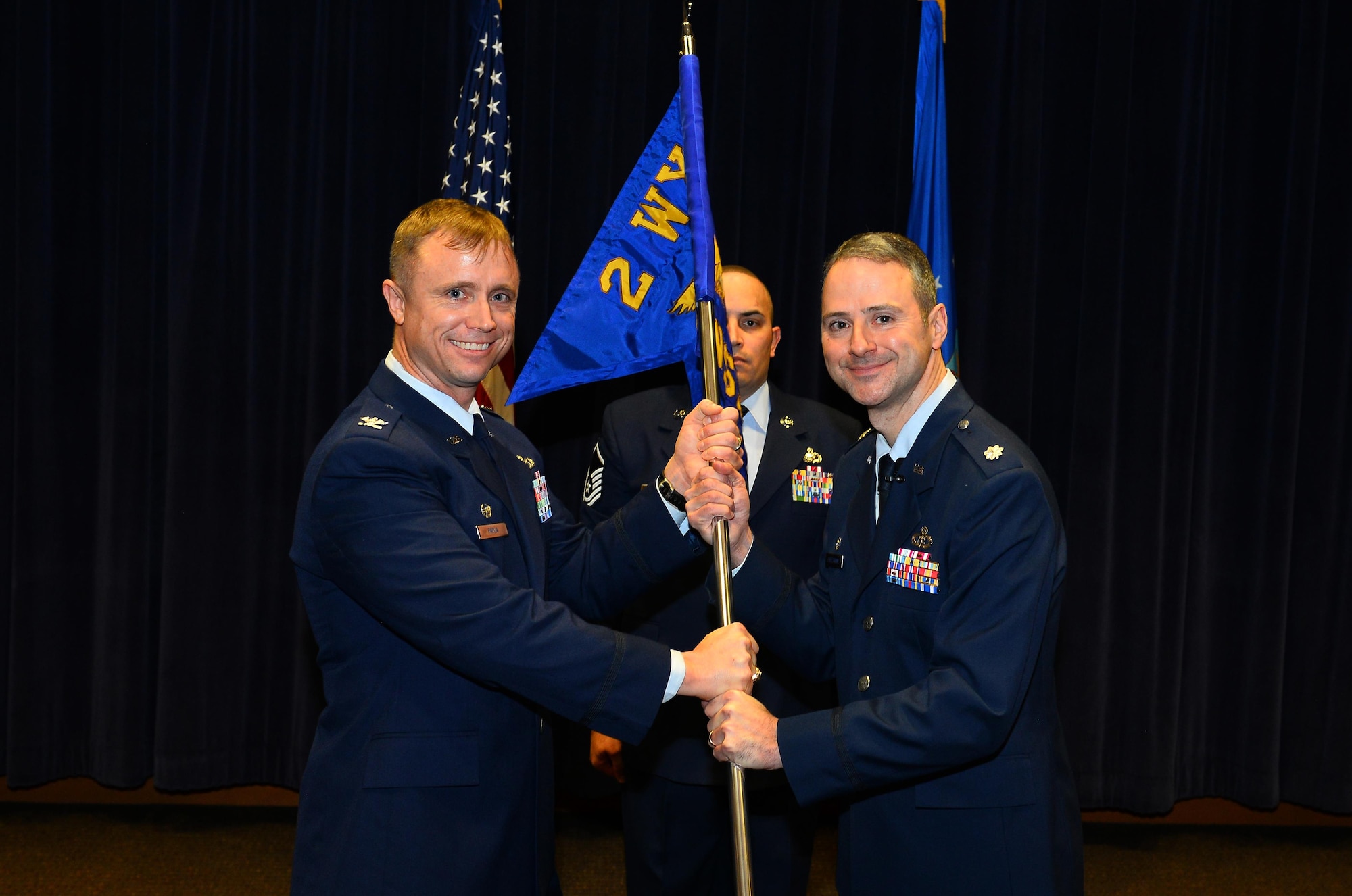 Lt. Col. Hugh J. Freestrom, 2d Weather Support Squadron commander, accepts the command guidon from Col. Jason E. Patla, 2d Weather Group commander, as he assumes command of the newly-formed 2d WSS during a ceremony at the 557th Weather Wing headquarters, Offutt Air Force Base Neb., Feb. 17, 2017. The 2d WSS, formerly Detachment 1, is comprised of three main flights; the commander’s support staff, operations and cyberspace operations. (U.S. Air Force photo by Josh Plueger)