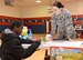 Airman 1st Class Eliza Patton, with the 72nd Dental Squadron, watches as a fifth-grader from Tinker Elementary learns how to correctly floss on a dental mold. Airmen from the Dental Clinic visited Tinker Elementary and the Tinker Child Development Centers throughout February for Children’s Dental Health Month. (Air Force photo by Kelly White)