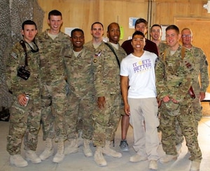 Staff Sgt. Jason Strong, second from right, attends the first LGBTQ+ event in the CENTCOM Area of Responsibility while deployed to Kandahar, Afghanistan, in June 2013. Directly to the left of him is John Phommavongsa, a contractor who would eventually help Strong facilitate the transfer of a year’s worth of school supplies for 500 girls to the Zabuli Education Center, a girls’ school just outside of Kabul, Afghanistan, in September 2016.