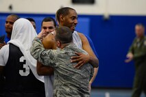Thomas King, U.S. Air Force Warfare Center, shares a post-game embrace with Robert Shaw, 4th Space Operations Squadron, following the intramural basketball championship game at Schriever Air Force Base, Colorado, Thursday, Feb. 23, 2017. 4 SOPS defeated USAFWC, 58-38, to win the title in a rematch of the 2016 championship game. (U.S. Air Force photo/Christopher DeWitt)