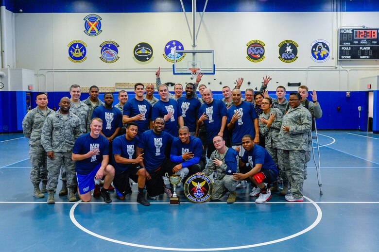 4th Space Operations Squadron members celebrate following their 58-38 win over the U.S. Air Force Warfare Center in the intramural basketball championship game at Schriever Air Force Base, Colorado, Thursday, Feb. 23, 2017. 4 SOPS earned the title and redemption for a loss to USAFWC in the 2016 championship game. (U.S. Air Force photo/Christopher DeWitt)
