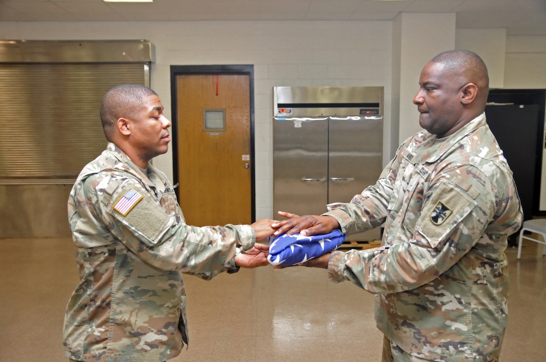 U.S. Army Reserve Soldiers Sgt. 1st Class Jeremy Reed, left, and Sgt. 1st Class Corey Abel, both with the 412th Theater Engineer Command, practice Military Funeral Honors at the Command headquarters in Vicksburg, Miss., Jan. 20, 2017. When the U.S. flag is presented, the point always faces the presenter. They were preparing for a Military Funeral Honors mission the next day. 