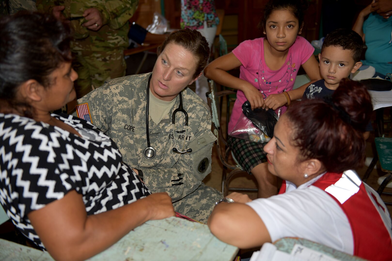 U.S. Army Master Sgt. Nicole Cope, Joint Task Force-Bravo Medical Element, examines a patient during a Medical Readiness Training Exercise in Corinto, Cortes, Feb. 17, 2017. Red Cross volunteers facilitated communication between patients and U.S. medical personnel. (U.S. Army photo by Maria Pinel)