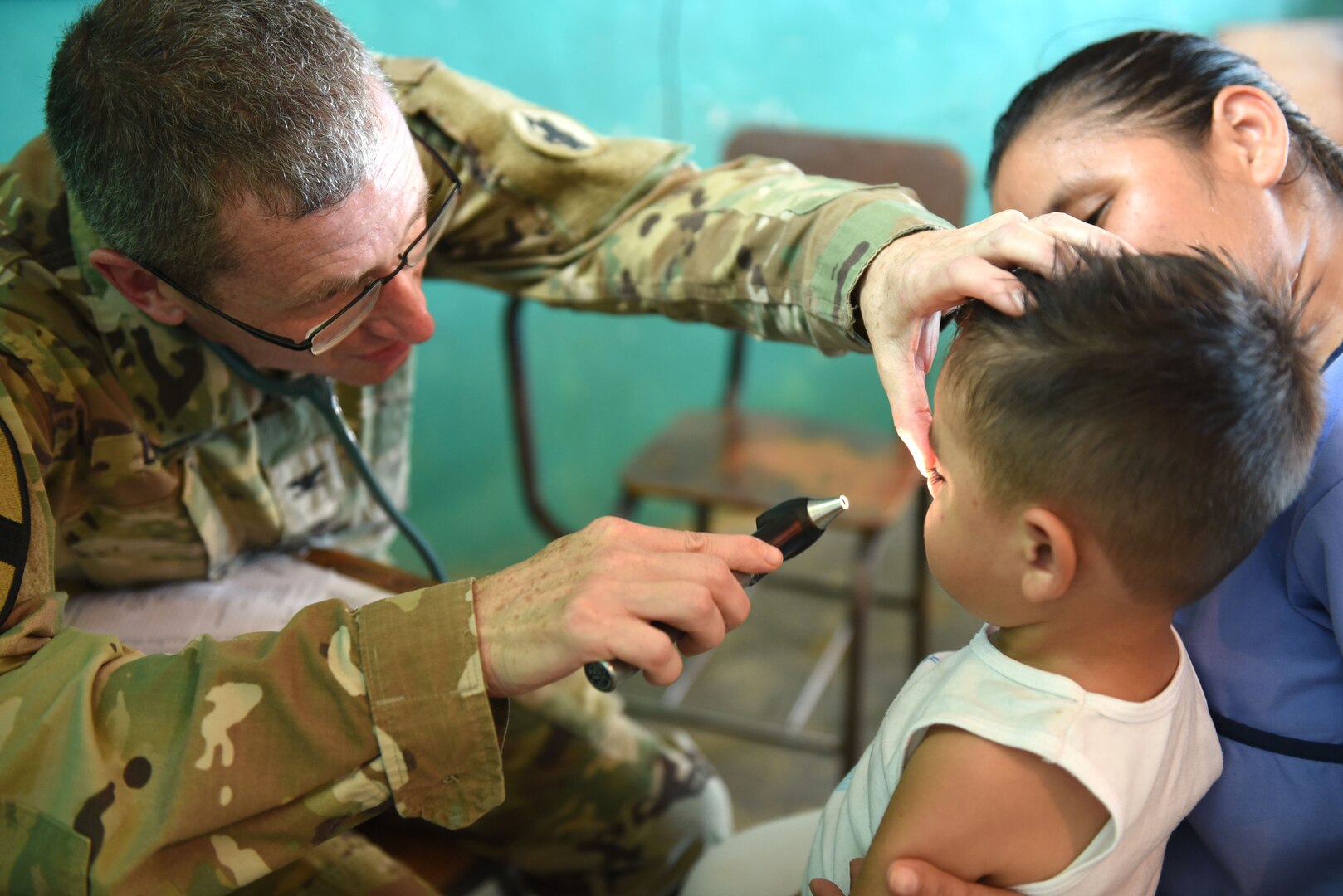U.S. Army Col. Douglas Lougee, Joint Task Force-Bravo Medical Element commander, examines a young boy during a Medical Readiness Training Exercise in Corinto, Cortes, Feb. 17, 2017. Lougee is also a pediatrician and had the opportunity to participate in a leadership role as well as a provider during the MEDRETE. (U.S. Army photo by Maria Pinel)