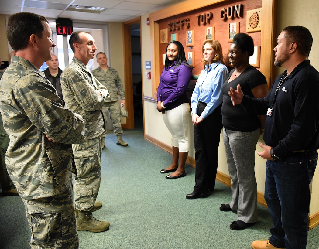 U.S. Air Force Col. Christopher Sage (far left), 4th Fighter Wing commander, and Maj. Gen. Scott Zobrist, 9th Air Force commander, speak with contractors during a base visit at Seymour Johnson Air Force Base, N.C., Feb. 15, 2017. Zobrist said contract employees are vital to helping the Air Force mission run smoothly. (U.S. Air Force photo by Airman 1st Class Kenneth Boyton)