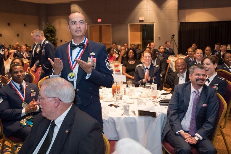 Master Sgt. David Roach, 43d Air Mobility Operations Group, and other members of the group respond to his selection as the group's First Sergeant of the Year during the annual awards banquet here Feb. 23. Roach was honored along with 10 other individual annual award winners, and one unit award winner. (U.S. Air Force photo/Marc Barnes)
