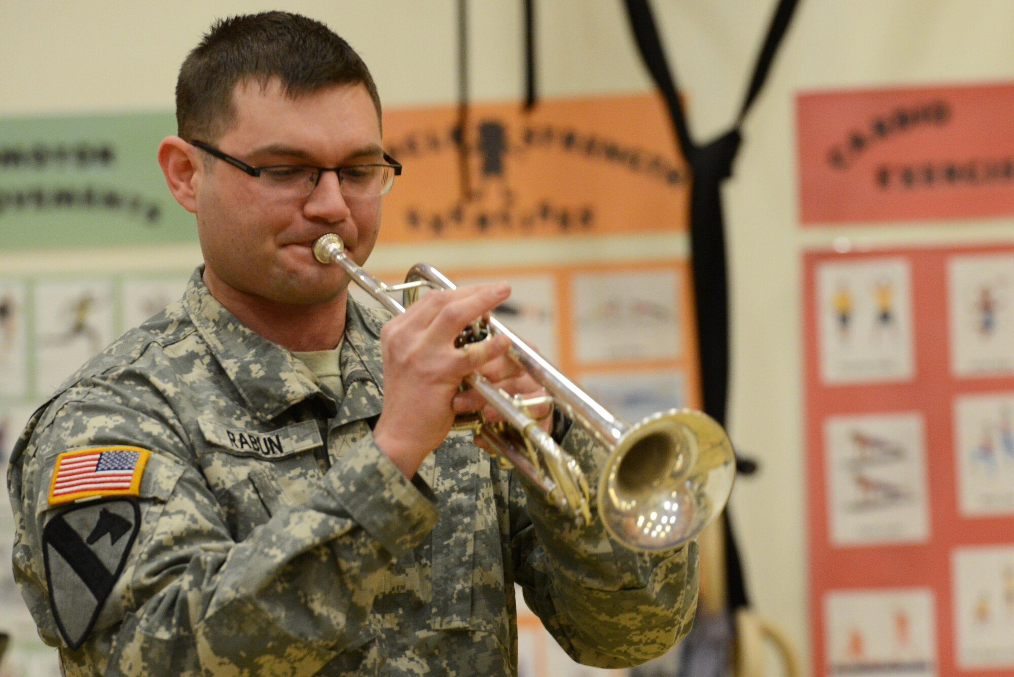 Army Sgt. William Rabun, trumpet player and group lead for the 9th Army Band group ‘Frigid Brass,’ performs for the children of Orion Elementary School, Joint Base Elmendorf-Richardson, Alaska, Feb. 21, 2017. ‘Frigid Brass’ performed many different genres of music and taught the children the first steps in playing each instrument to spark an interest in the musical arts. 