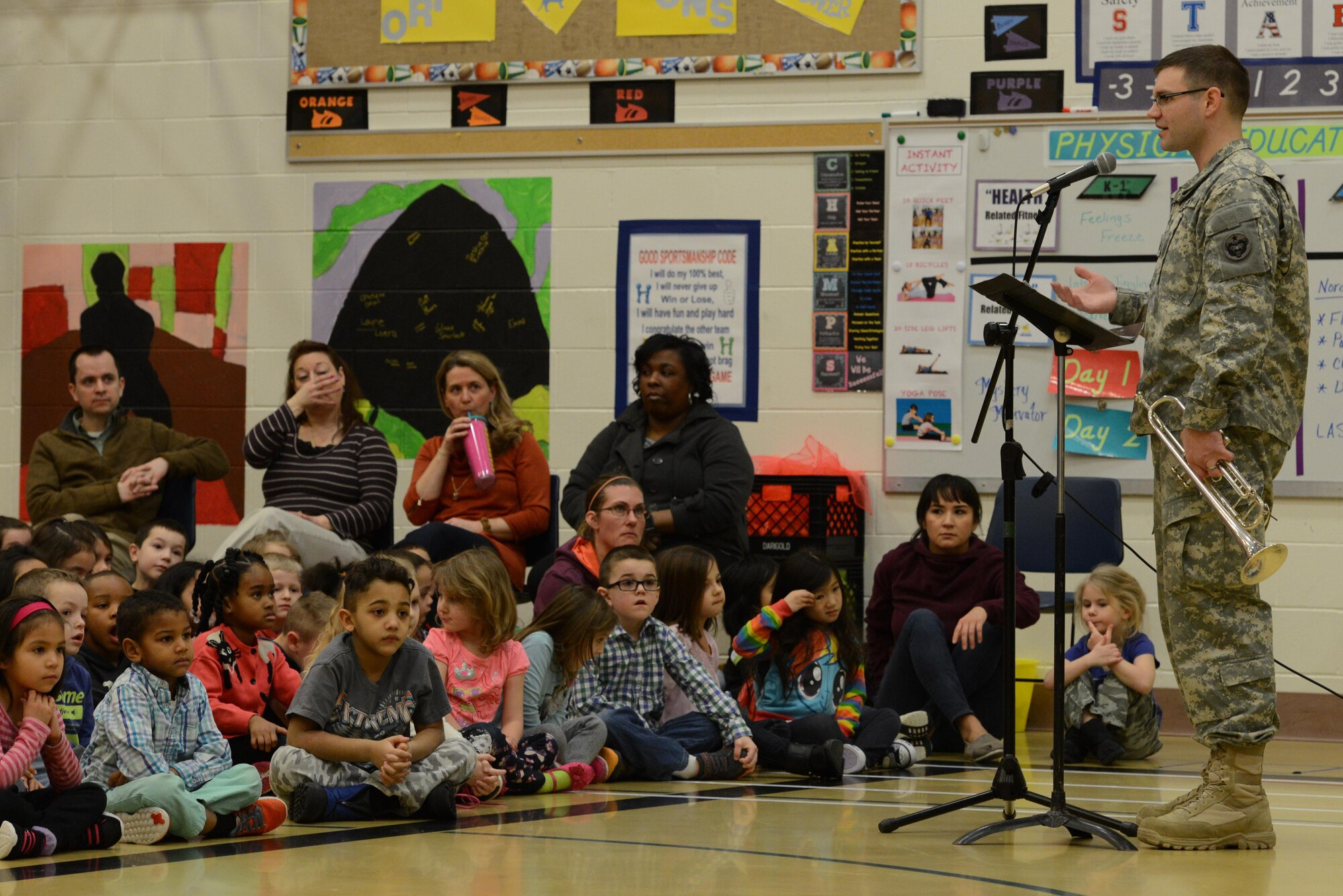 Army Sgt. William Rabun, trumpet player and group lead of the 9th Army Band group ‘Frigid Brass,’ speaks to the children of Orion Elementary School, Joint Base Elmendorf-Richardson, Alaska, Feb. 21, 2017. ‘Frigid Brass’ performed many different genres of music and taught the children the first steps in playing each instrument to spark an interest in the musical arts. 