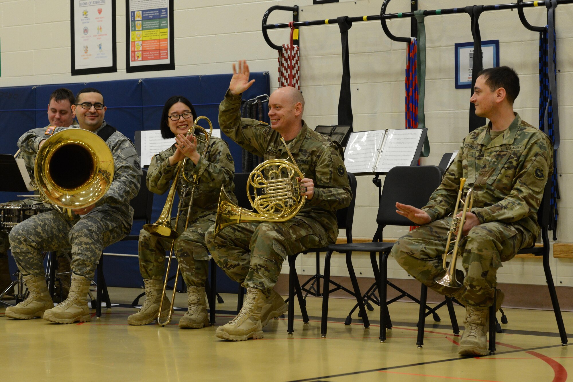 Specialist Jeremy Leach, horn player for the 9th Army Band group ‘Frigid Brass,’ waves to the audience of Orion Elementary School, Joint Base Elmendorf-Richardson, Alaska, Feb. 21, 2017. ‘Frigid Brass’ performed many different genres of music and taught the children the first steps in playing each instrument to spark an interest in the musical arts. 