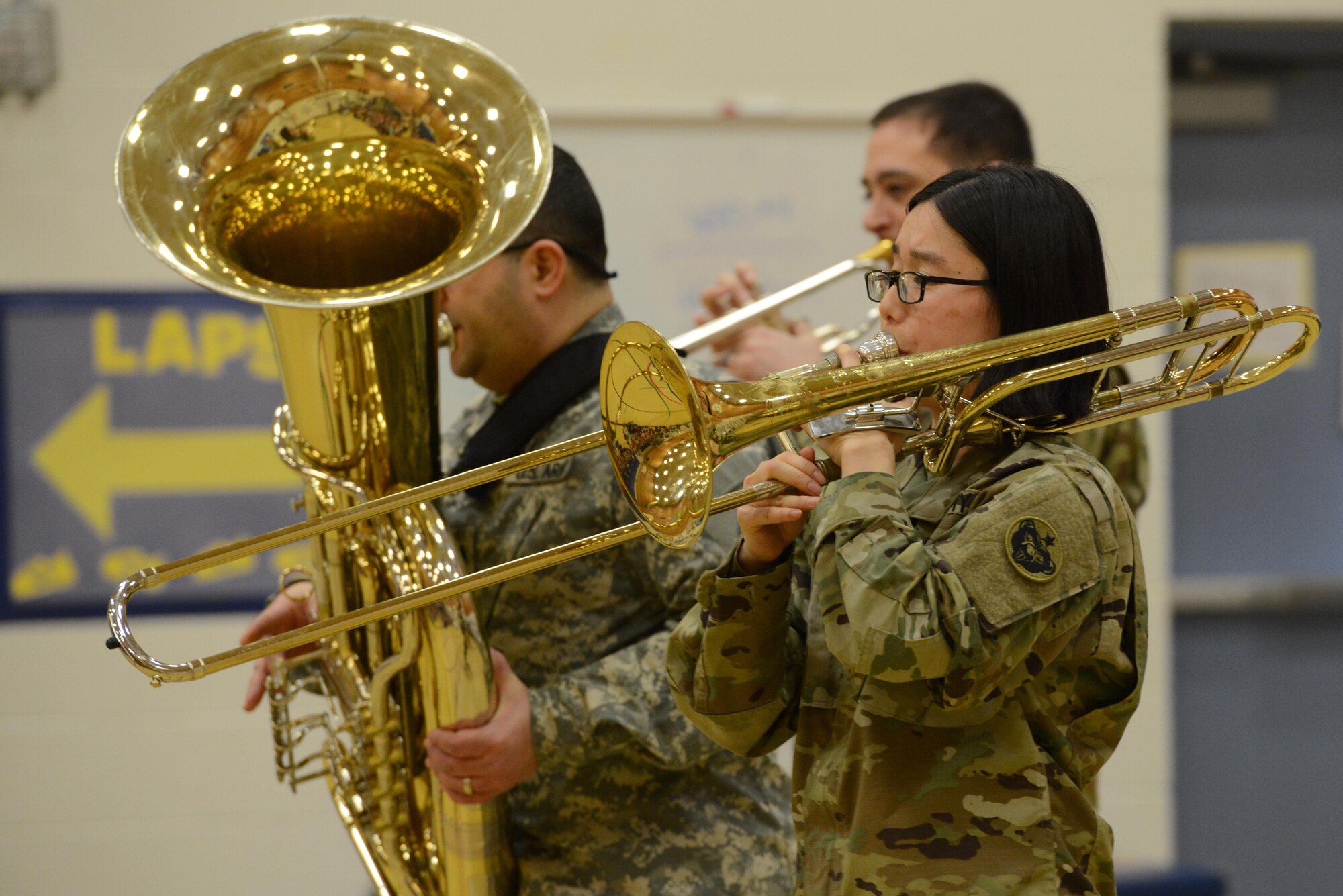 Army Staff Sgt. Nami Fowler, trombone player for the 9th Army Band group ‘Frigid Brass,’ performs for the children of Orion Elementary School, Joint Base Elmendorf-Richardson, Alaska, Feb. 21, 2017. ‘Frigid Brass’ performed many different genres of music and taught the children the first steps in playing each instrument to spark an interest in the musical arts. 