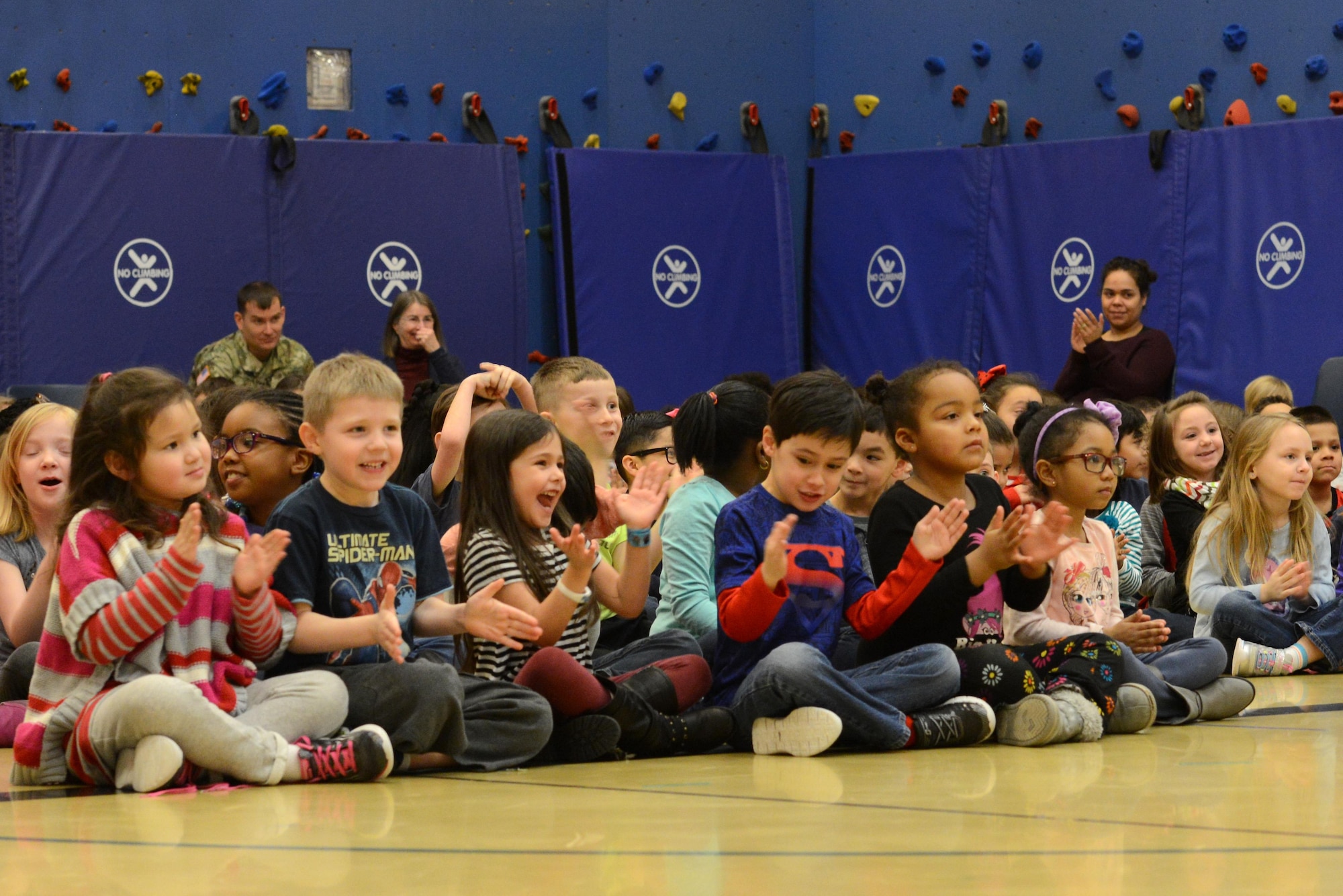Children of Orion Elementary School applaud a 9th Army Band group ‘Frigid Brass’ performance at Joint Base Elmendorf-Richardson, Alaska, Feb. 21, 2017. ‘Frigid Brass’ performed many different genres of music and taught the children the first steps in playing each instrument to spark an interest in the musical arts. 