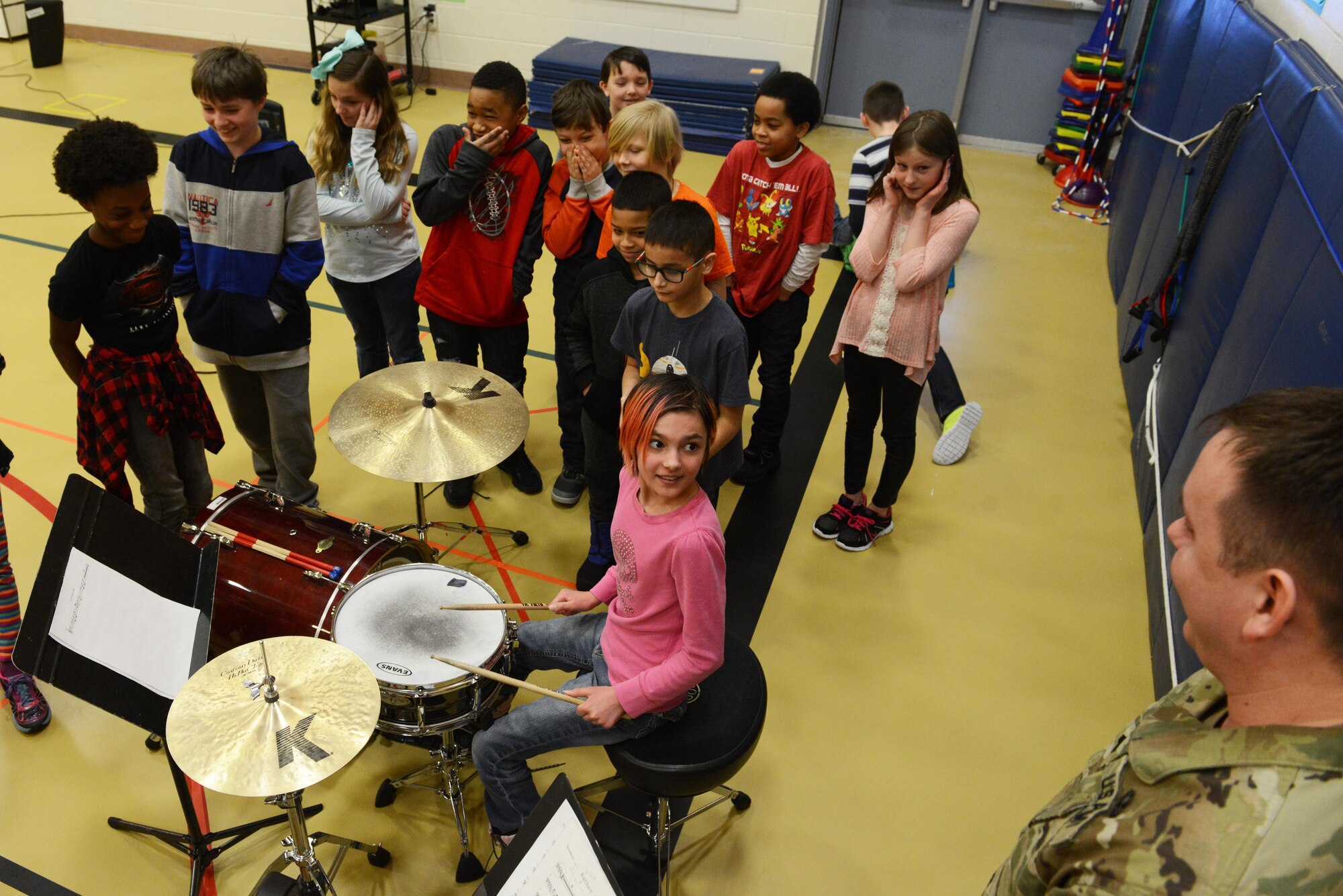 Army Sgt. Kevin Drysdale, Percussion playerforthe 9th Army Band and group 'Frigid Brass,' teaches 4th and 5th graders how to play the drums at Orion Elementary School, Joint Base Elmendorf-Richardson, Alaska, Feb. 21, 2017. ‘Frigid Brass’ performed many different genres of music and taught the children the first steps in playing each instrument to spark an interest in the musical arts. 