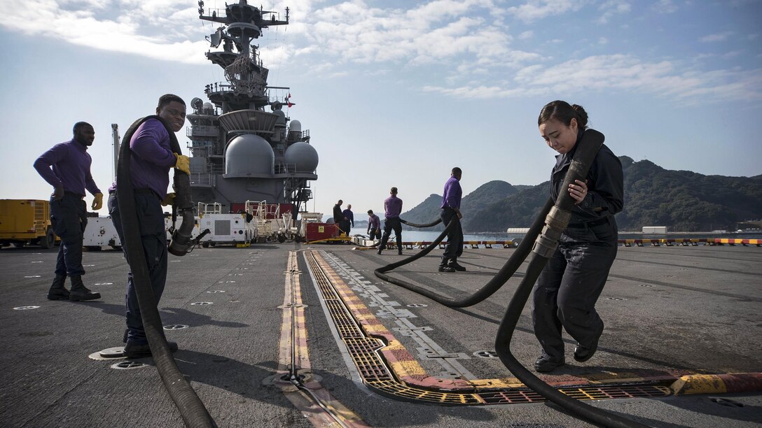 Navy seamen prepare a JP-5 fuel hose for inspection on the flight deck of the USS Bonhomme Richard in Sasebo, Japan, Feb. 27, 2017. The amphibious assault ship is operating in the Indo-Asia-Pacific region, ready for any type of contingency. The seamen are aviation boatswain's mates (fuel). Navy photo by Petty Officer 2nd Class Diana Quinlan