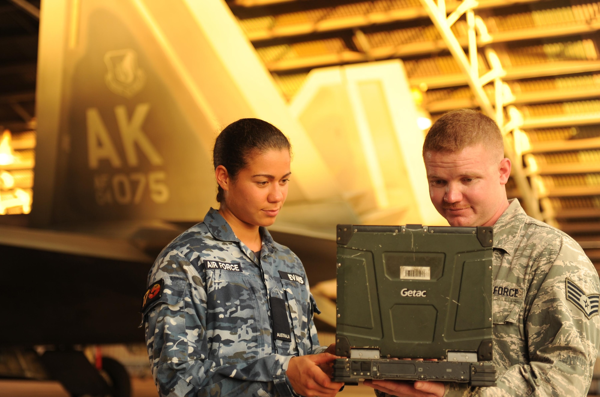 Royal Australian Air Force Aircraft Woman Eqxelle Evans, 17 Squadron Fire and Rescue, and U.S. Air Force Staff Sgt. Corbin King, 90th Aircraft Maintenance Unit, review emergency shutdown procedures of an F-22 Raptor at RAAF Base Tindal Feb. 16, 2016. Twelve F-22s and approximately 200 U.S. Air Force Airmen are at RAAF Base Tindal as part of the Enhanced Air Cooperation Initiative under the Force Posture Agreement between the U.S. and Australia. (U.S. Air Force photo by Staff Sgt. Alexander Martinez)