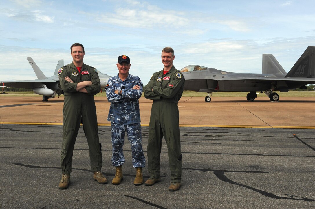 From left: Royal Australian Air Force Flight Lieutenant William Grady, 90th Fighter Squadron exchange pilot; Wing Commander Andrew Tatnell, RAAF Base Tindal Senior Australian Defence Force Officer; and U.S. Air Force Lt. Col. David Skalicky, 90th FS commander, pose for a photo in front of a RAAF 75 Squadron F/A-18A/B Hornet and U.S. 90th FS F-22 Raptor at RAAF Base Tindal, Australia, Feb. 24, 2017. Twelve F-22 Raptors and approximately 200 U.S. Air Force Airmen are in Australia as part of the Enhanced Air Cooperation, an initiative under the Force Posture Agreement between the U.S. and Australia. (U.S. Air Force photo by Staff Sgt. Alexander Martinez)