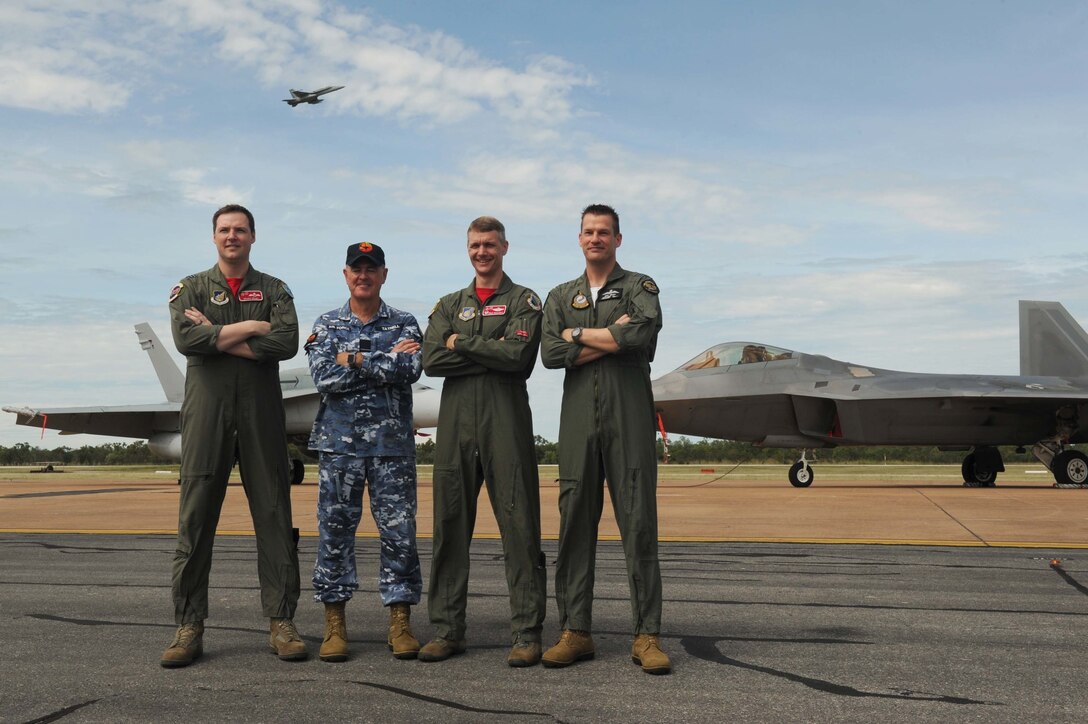 From left: Royal Australian Air Force Flight Lieutenant William Grady, 90th Fighter Squadron exchange pilot; Wing Commander Andrew Tatnell, RAAF Base Tindal Senior Australian Defence Force Officer; U.S. Air Force Lt. Col. David Skalicky, 90th FS commander; and Wing Commander Mick Grant, 75 Squadron commander pose for a photo in front of a RAAF 75 SQ F/A-18A/B Hornet and U.S. 90th FS F-22 Raptor at RAAF Base Tindal, Australia, Feb. 24, 2017. Twelve F-22 Raptors and approximately 200 U.S. Air Force Airmen are in Australia as part of the Enhanced Air Cooperation, an initiative under the Force Posture Agreement between the U.S. and Australia. (U.S. Air Force photo by Staff Sgt. Alexander Martinez)
