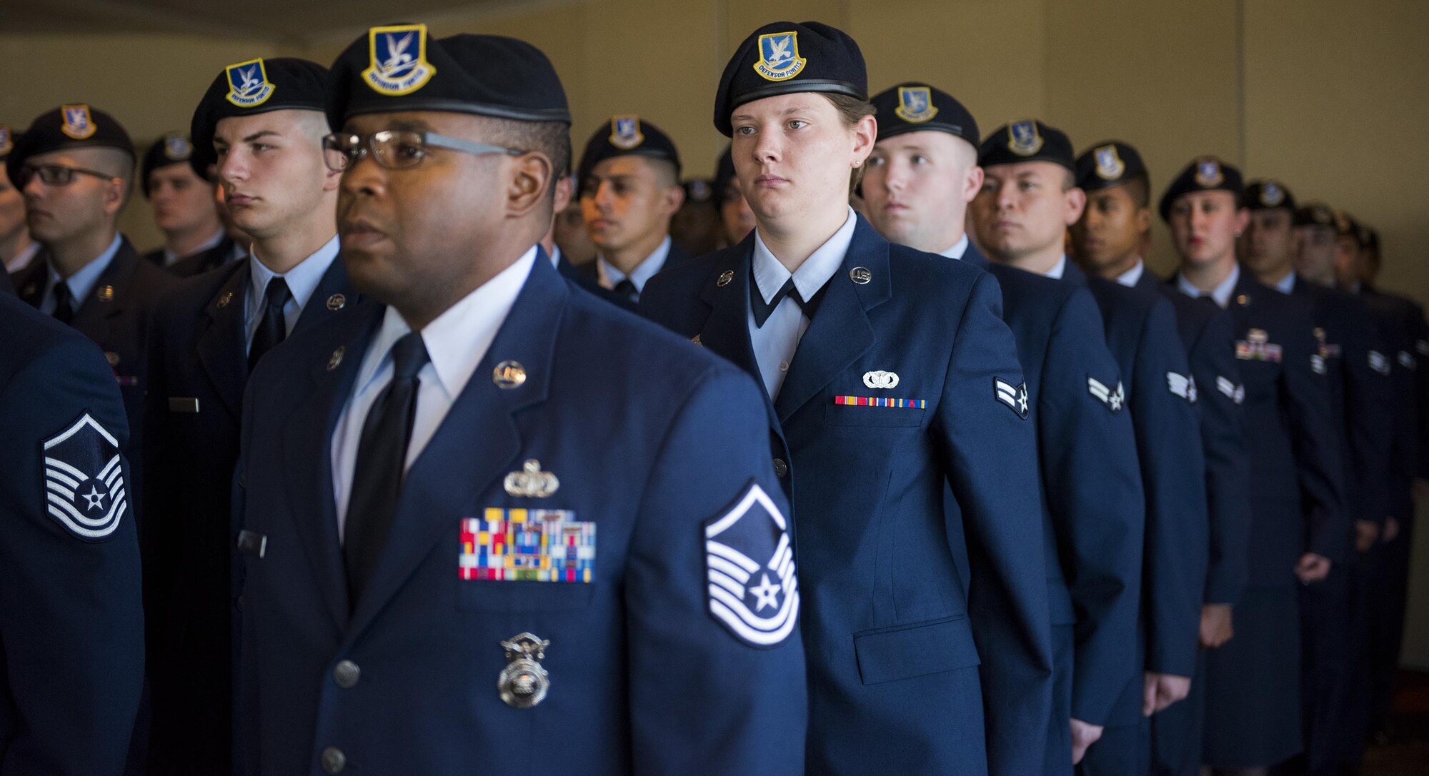 A flight of 96th Security Forces Squadron Airmen stand at attention during the National Anthem during a boat-dedication ceremony Feb. 24 at Eglin Air Force Base, Fla.  The boat was dedicated to Senior Airman Nathan Sartain, a security forces Airman from Pensacola, died in an aircraft crash while deployed in 2015.  The newest patrol boat in the Eglin fleet bears his name to honor his service and sacrifice. (U.S. Air Force photo/Samuel King Jr.)