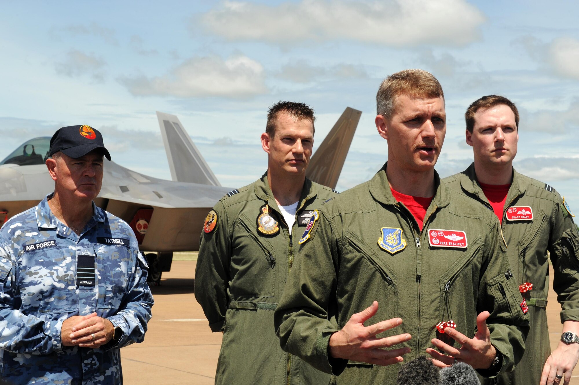U.S. Air Force Lt. Col. David Skalicky, 90th FS commander, speak to members of the media, accompanied by Royal Australian Air Force Wing Commander Andrew Tatnell, RAAF Base Tindal Senior Australian Defence Force Officer; Wing Commander Mick Grant, 75 Squadron commander; and Flight Lieutenant William Grady, 90th Fighter Squadron exchange pilot; at RAAF Base Tindal, Australia, Feb. 24, 2017. Twelve F-22 Raptors and approximately 200 U.S. Air Force Airmen are in Australia as part of the Enhanced Air Cooperation, an initiative under the Force Posture Agreement between the U.S. and Australia. (U.S. Air Force photo by Staff Sgt. Alexander Martinez)