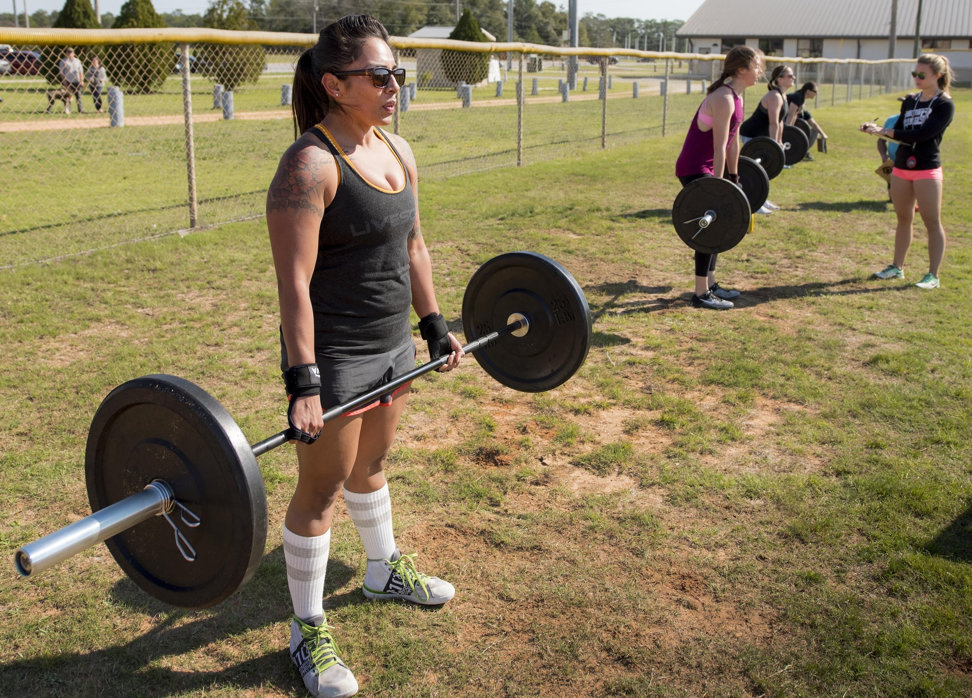 Four competitors perform deadlifts during the Eglin’s Fittest competition Feb. 25 at Eglin Air Force Base, Fla.  Male and female challengers fought to complete weightlifting, cardio and callisthenic exercises over a timed period.  The person with the most points (earned through reps and quickness) earned the title of “Eglin’s Fittest”.  (U.S. Air Force photo/Samuel King Jr.)
