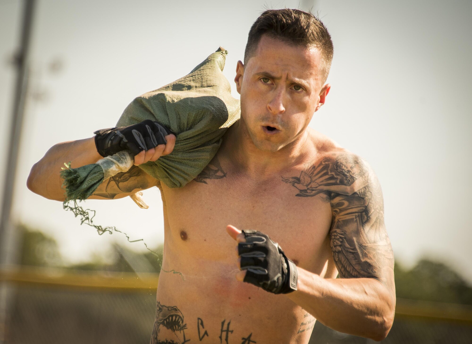 A competitor carries a sandbag over her shoulder during the Eglin’s Fittest competition Feb. 25 at Eglin Air Force Base, Fla.  Male and female challengers fought to complete weightlifting, cardio and callisthenic exercises over a timed period.  The person with the most points (earned through reps and quickness) earned the title of “Eglin’s Fittest”.  (U.S. Air Force photo/Samuel King Jr.)