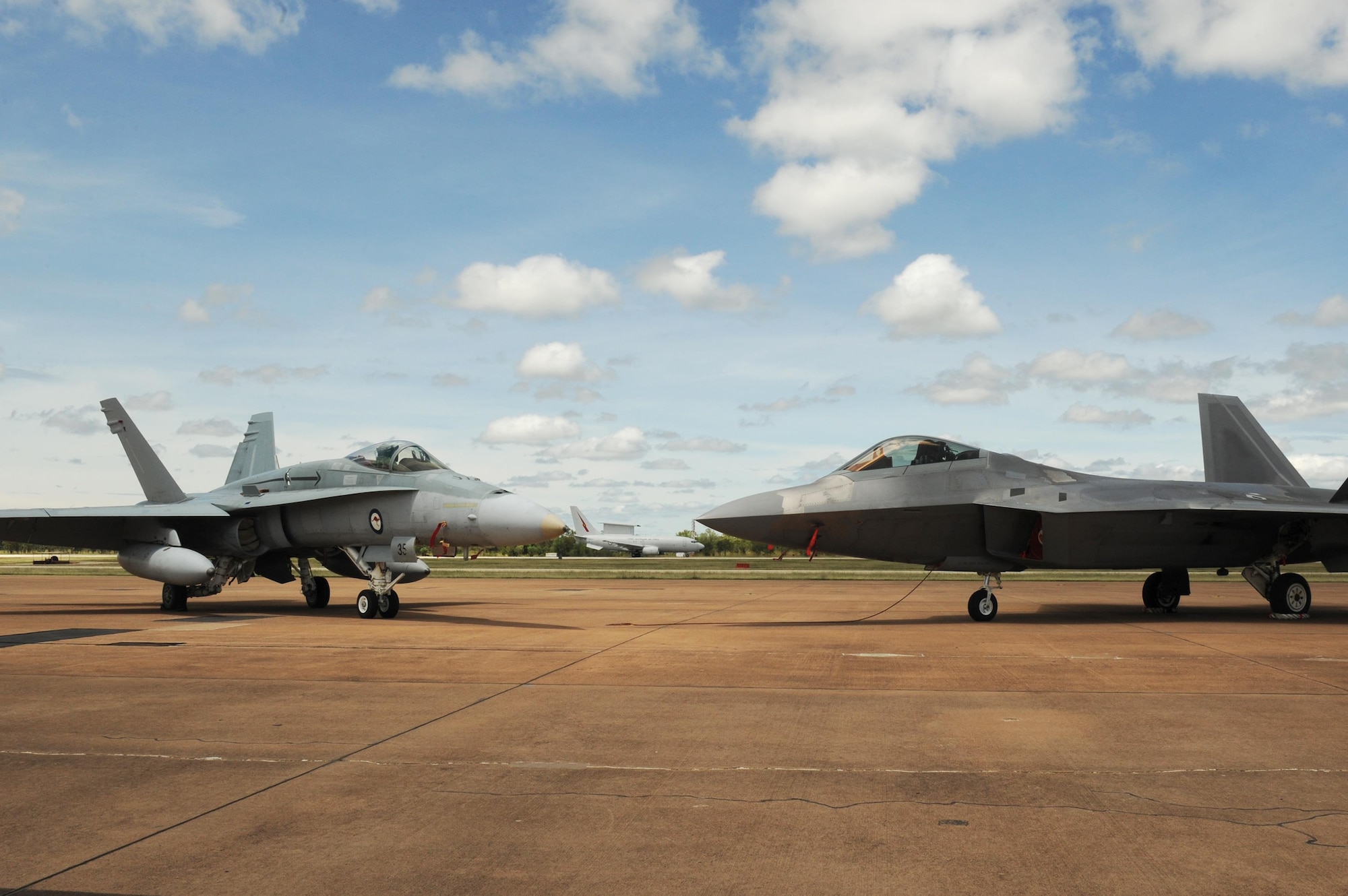 A Royal Australian Air Force E-7A Wedgetail taxies behind a RAAF 75 Squadron F/A-18A/B Hornet and U.S. Air Force 90th Fighter Squadron F-22 Raptor at RAAF Base Tindal, Australia, Feb. 24, 2017. Twelve F-22 Raptors and approximately 200 U.S. Air Force Airmen are in Australia as part of the Enhanced Air Cooperation, an initiative under the Force Posture Agreement between the U.S. and Australia. (U.S. Air Force photo by Staff Sgt. Alexander Martinez)