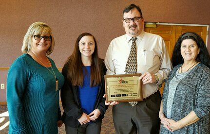 Shown above are NSWC Crane’s Comptroller Department employees Natalee Woodward, Chelsey Bailey, Roger Clark and Kathy Burns displaying the Plaque and Platinum Plate that their department earned for achieving 100% participation of the CFC.