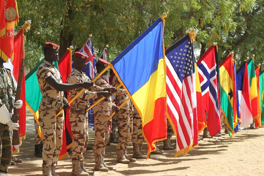 Chadian soldiers raise the flags of partner nations participating in Flintlock 17 during the opening ceremony Feb. 27, 2017. Flintlock is an annual special operations exercise involving more than 20 nation forces that strengthens security institutions, promotes multilateral sharing of information, and develops interoperability among partner nations in North West Africa. Army photo by Staff Sgt. Terrance Payton