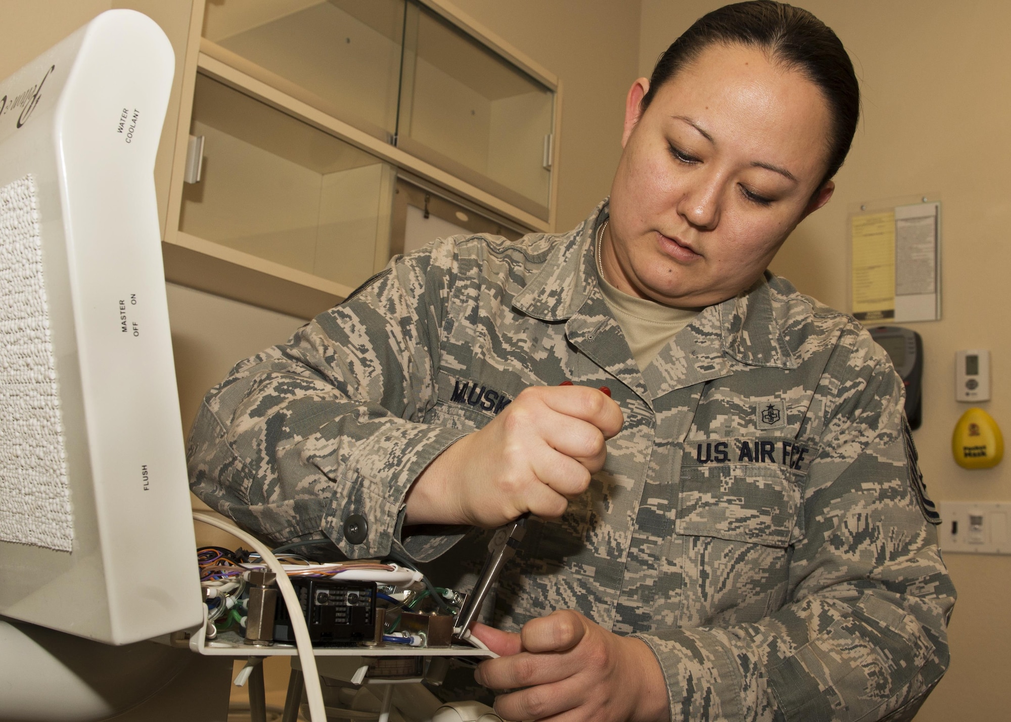 Tech. Sgt. Linsey McCluskey, 5th Medical Support Squadron medical maintenance NCO-in-charge, disconnects a dental hose from the dental chair at the 5th Medical Group clinic at Minot Air Force Base, N.D., Feb. 8, 2017. The hose connects water and air to one device for use with patients. (U.S. Air Force photo/Airman 1st Class Alyssa M. Akers)