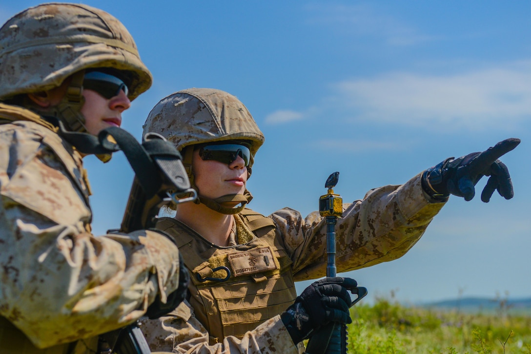 Marine Corps 2nd Lt. Virginia Brodie points out an enemy position to 2nd Lt. Katherine Boy 