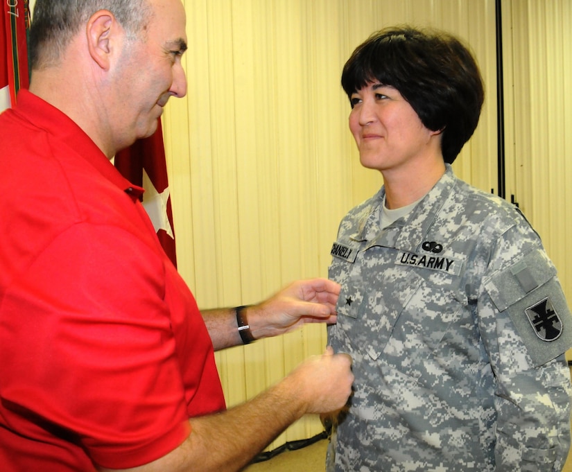 Army Reserve Brig. Gen. Miyako Schanely, deputy commander, 412th Theater Engineer Command, is pinned her one star by her husband, Steve, in a ceremony held at the TEC's headquarters in Vicksburg, Miss. Schanely, a resident of Black River, N.Y., is the first female Japanese-American and the first female Engineer in the Army Reserve and second in the Army to be promoted to General Officer.