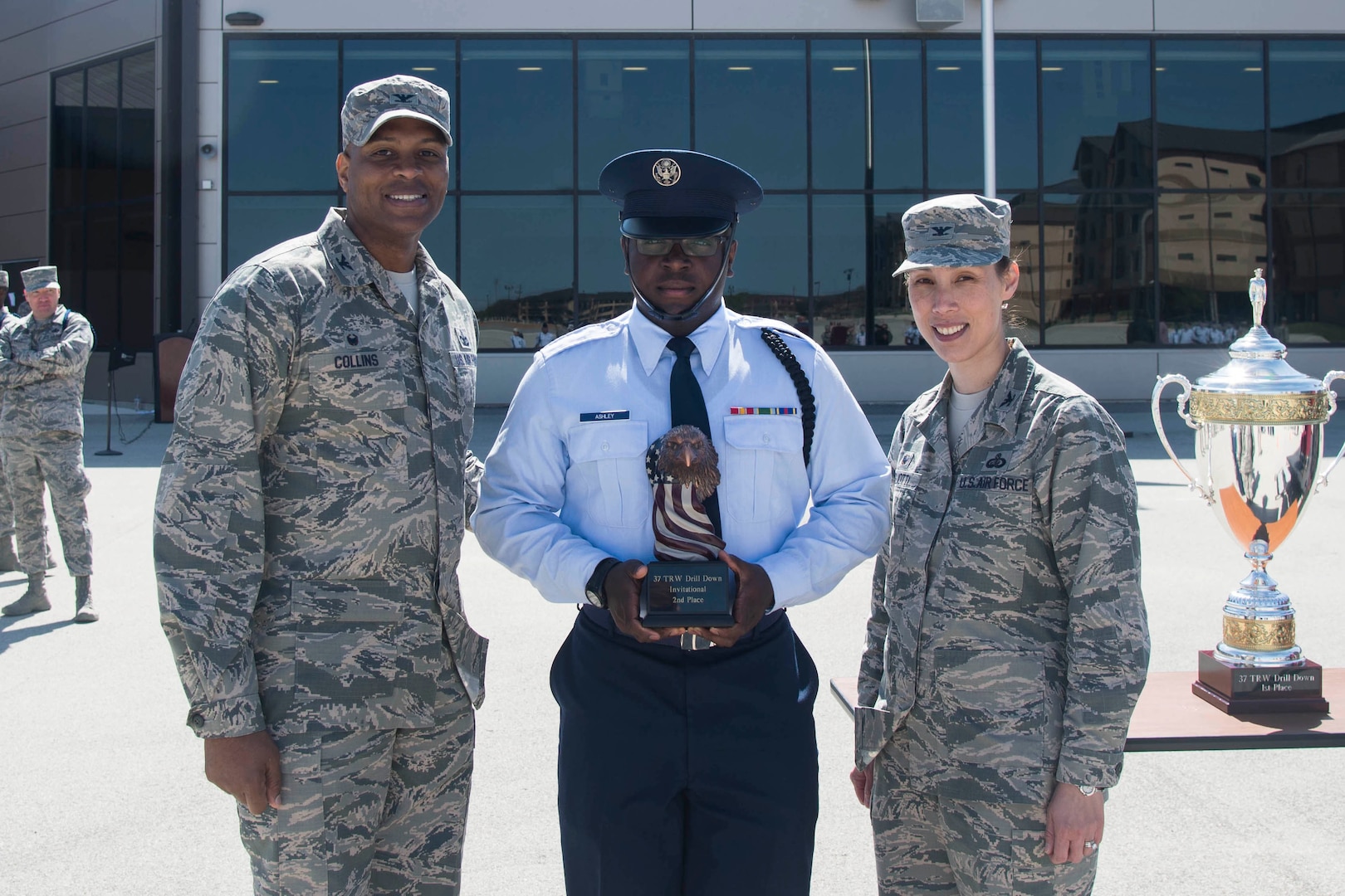 The trophy for second place in the 37th Training Wing Drill Down invitational is awarded to a representative from the 17th Training Wing drill team, by Col. Roy W. Collins, 37th TRW commander, and Col. Bridget Gigliotti, 37th Training Group commander, at the Pfingston Reception Center at Joint Base San Antonio-Lackland, Texas, Feb. 25, 2017. The 17th TRW team traveled from Goodfellow Air Force Base, Texas, to participate in the competition for the first time. 