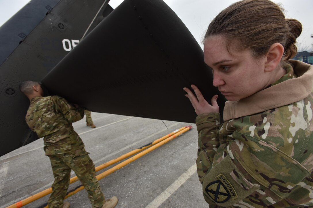 Army Spcs. Emily McLead, right, and Robert Elliott, with the 10th Combat Aviation Brigade, assemble a UH-60 Black Hawk helicopter it was unloaded from a ship at the Port of Thessaloniki, Greece, Feb. 25, 2017. Army photo by Master Sgt. Crista Mary Mack