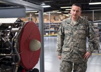 Master Sgt. Ryan Love, Air Education and Training Command equipment manager, examines an aircraft engine during a walk-through of an aircraft maintenance building Feb. 27 at Joint Base San Antonio-Randolph. Love was recently awarded the AETC Outstanding Air Force Logistics Readiness Enlisted Staff of the Year honor. (U.S. Air Force photo by Airman 1st Class Lauren Parsons/Released)