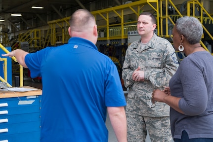 Master Sgt. Ryan Love (center), Air Education and Training Command equipment manager, speaks with Bryan Kammerdiener, 575th Aircraft Maintenance Squadron engineering technician, and Sharon Walker, 502nd Logistics Readiness Squadron equipment accountability element technician, outside an aircraft maintenance hangar Feb. 27 at Joint Base San Antonio-Randolph. Love was recently awarded the AETC Outstanding Air Force Logistics Readiness Enlisted Staff of the Year honor. (U.S. Air Force photo by Airman 1st Class Lauren Parsons/Released)