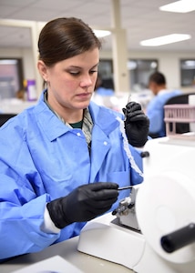 Staff Sgt. Katie Manfred, a 959th Clinical Support Squadron histology technician, cuts a block of tissue sample for testing at the San Antonio Military Medical Center, Joint Base San Antonio-Fort Sam Houston, Jan. 13, 2017. The pathology laboratory serves as a hub for sample testing; the staff receives and processes tissue samples from more than 90 military treatment facilities around the world. (U.S. Air Force photo/Staff Sgt. Jerilyn Quintanilla)
