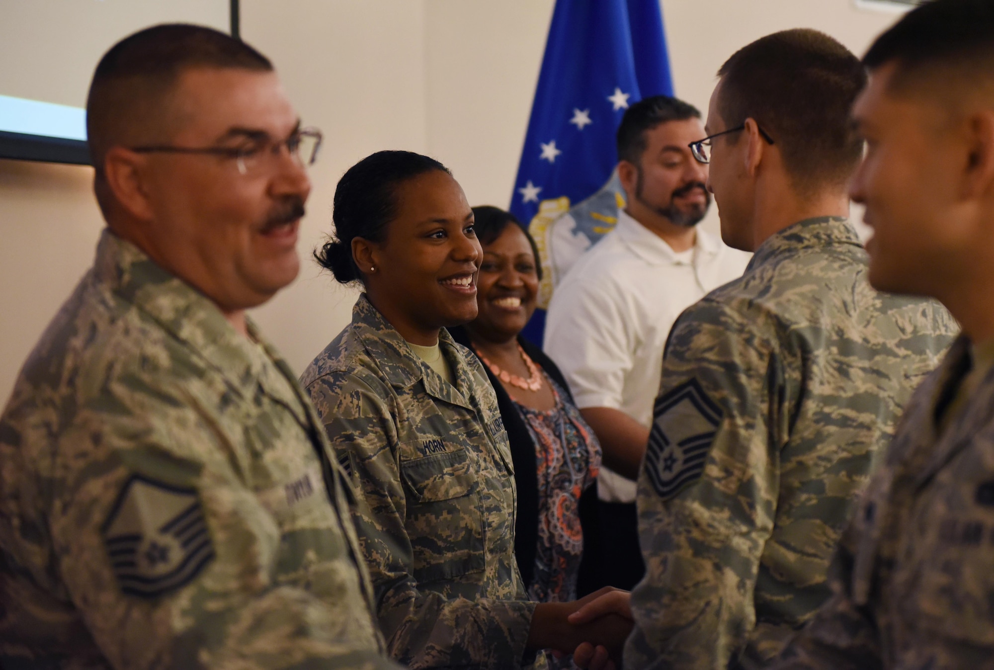 Mighty Eighth Airmen are congratulated during the 2016 Headquarters Eighth Air Force Annual Awards ceremony held at Barksdale Air Force Base, La., Feb. 27, 2017. Maj. Gen. Thomas Bussiere, Eighth Air Force commander, and Chief Master Sgt. Alan Boling, Eighth Air Force command chief, presented awards to seven Airmen and civilians assigned to Headquarters Eighth Air Force to recognize their professionalism and successes throughout the year, with a focus on appreciation toward family members. Air Force Global Strike Command announced that 2017 was dubbed “Year of the Family,” which focuses on efforts that directly impact the quality of life for Airmen and their family members. (U.S. Air Force photo by Senior Airman Erin Trower) 