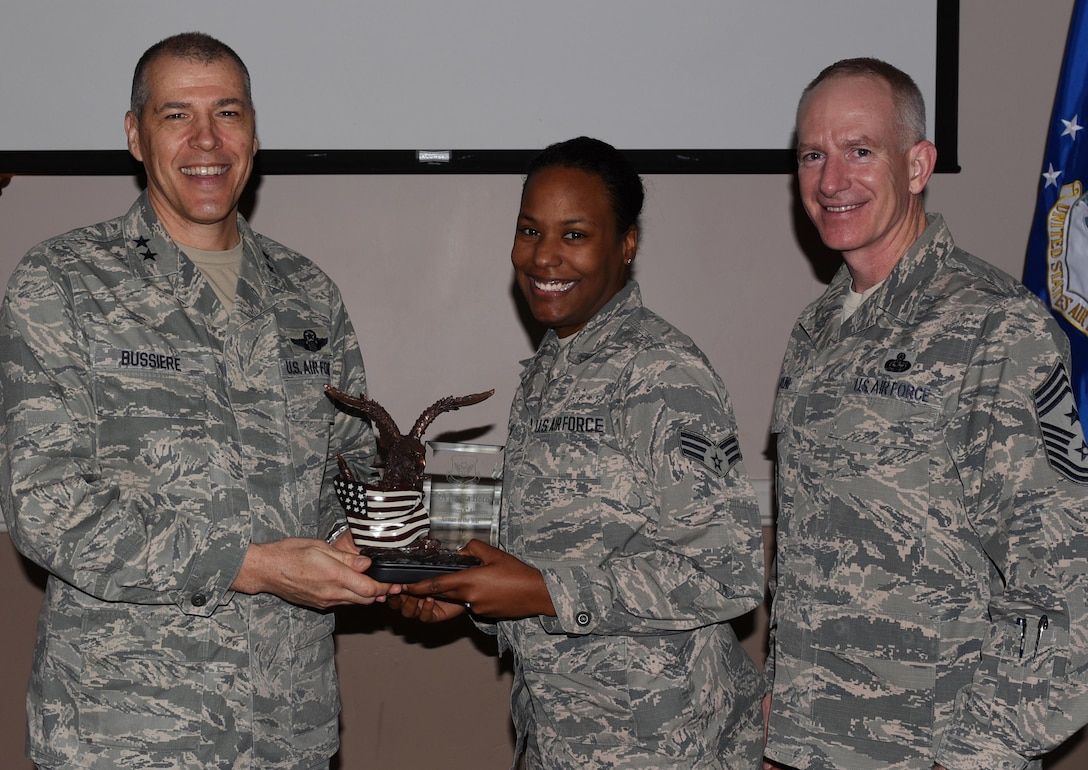 U.S. Air Force Senior Airman Jessica Horn, 608th Air Operations Squadron, center, is named Airman of the Year during the 2016 Headquarters Eighth Air Force Annual Awards ceremony at Barksdale Air Force Base, La., Feb. 27, 2017. Maj. Gen. Thomas Bussiere, Eighth Air Force commander, and Chief Master Sgt. Alan Boling, Eighth Air Force command chief, presented awards to Airmen and civilians assigned to Headquarters Eighth Air Force to recognize their professionalism and successes throughout the year. (U.S. Air Force photo by Senior Airman Erin Trower)